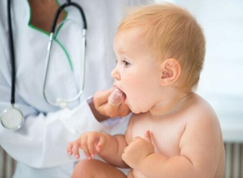 a dentist cleaning a baby’s teeth toddler's first dental checkup