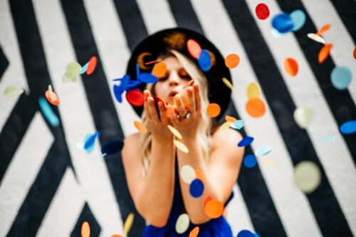 Collette Collabs blowing confetti Collette Collabs blowing confetti