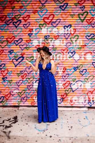 Collette Collabs founder in front of a graffiti wall Collette Collabs founder in front of a graffiti wall